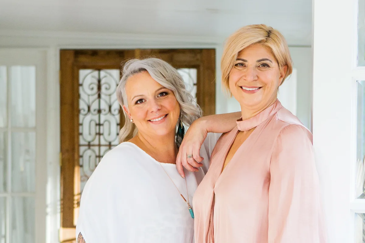 FOCUS co-founders Jodie Fielden and Adrienne Varga standing together in a bright home interior